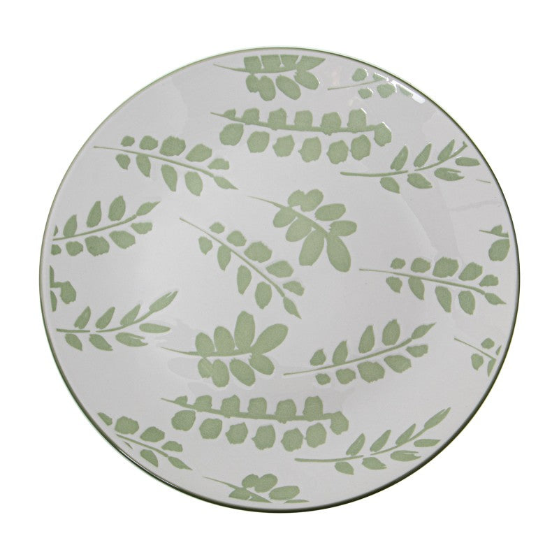 Vista superior del plato de cena de porcelana blanca con diseño de hojas verdes distribuidas sobre toda la superficie