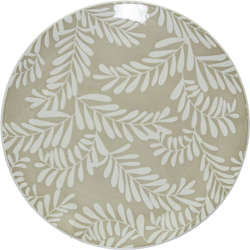 Vista superior de plato llano de porcelana beige con estampado de hojas blancas cubriendo toda la superficie