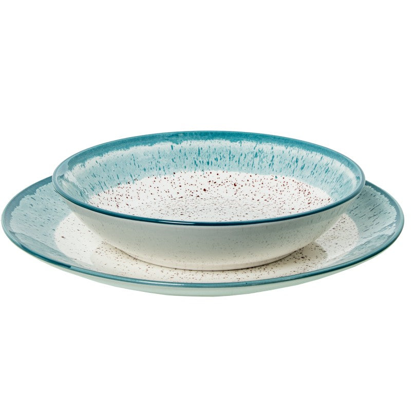 Tazón de porcelana con borde azul moteado sobre plato a juego, vista frontal sobre fondo blanco