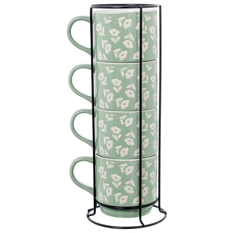 Set de 4 mugs de cerámica verde con estampado floral blanco, apilados en soporte metálico negro