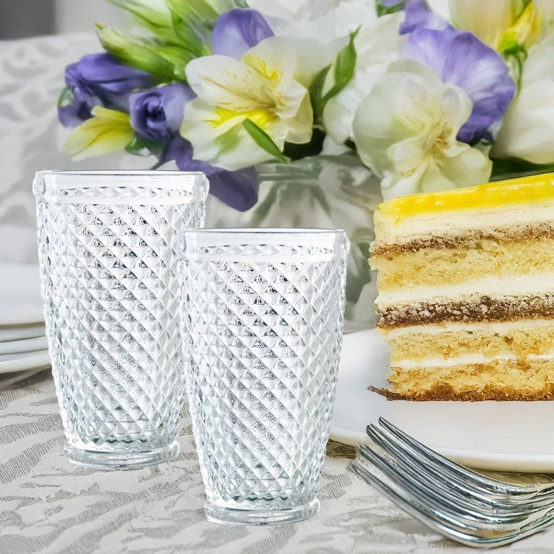 Dos vasos de cristal deco diamante junto a un pastel y flores, mesa elegante