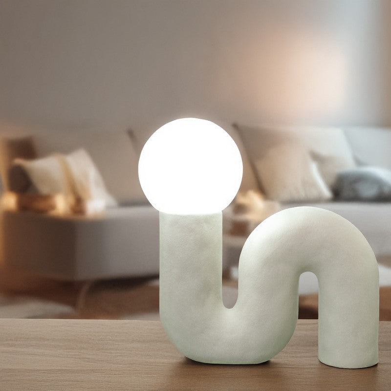 Lámpara de cerámica blanca encendida con luz cálida en salón moderno