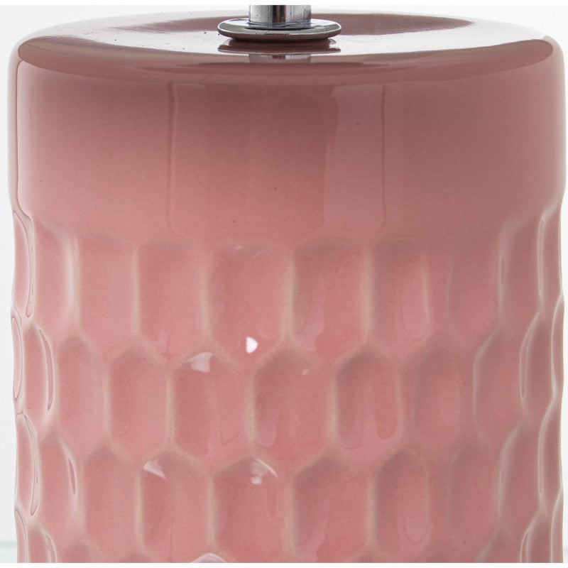 Primer plano del esmalte rosa brillante y la textura hexagonal en relieve de la base de cerámica