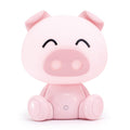 Lámpara LED con forma de cerdito rosa sentado, ojos cerrados y expresión tierna