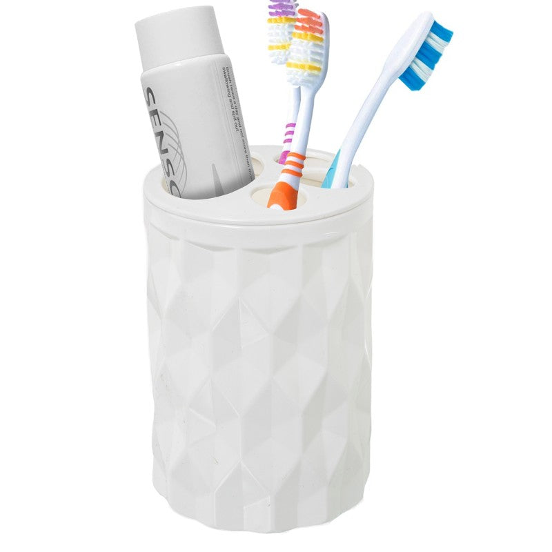 Vaso blanco en uso con cepillos de dientes y pasta dental colocados en sus compartimentos