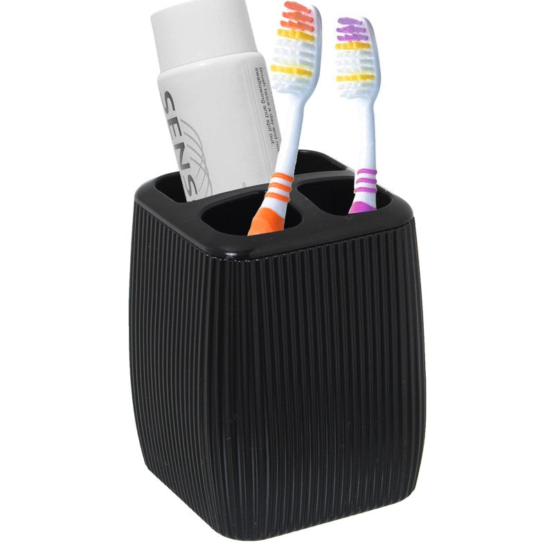 Vaso porta cepillos en uso con cepillos de dientes y pasta dental